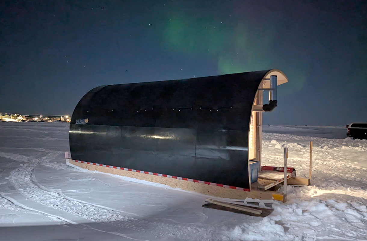 Portable research lab with northern lights behind